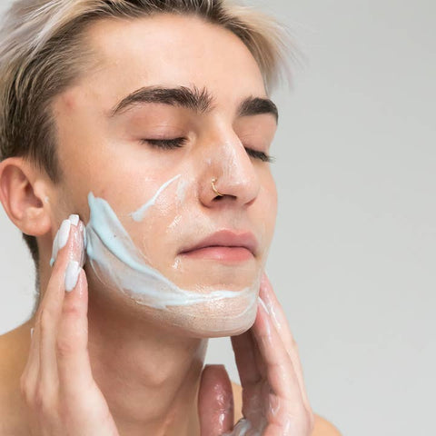 person using blue azul cleanser by om
