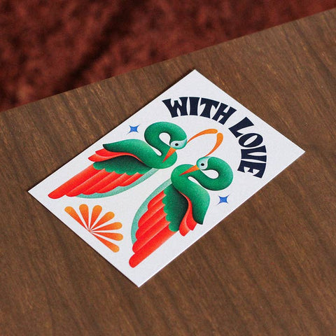 Colorful bird design with 'WITH LOVE' text on a wooden surface