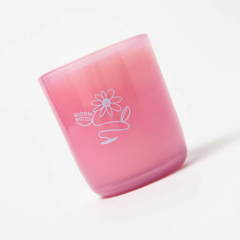 Pink tumbler with 'BLOOM' and flower design on a white background