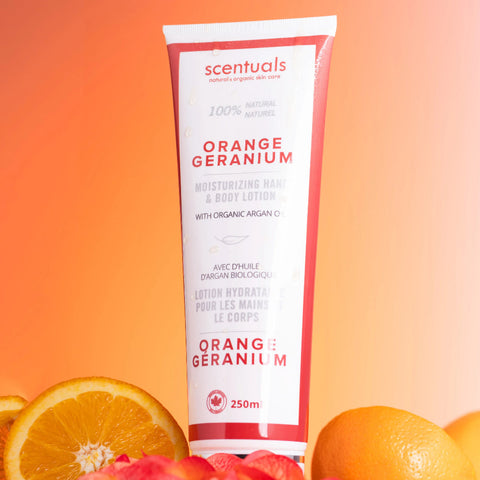 Scentuals Orange Geranium lotion tube with oranges on an orange gradient background