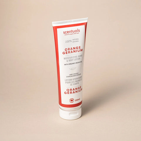 Tube of Scentuals Orange Geranium hand and body lotion on a beige background