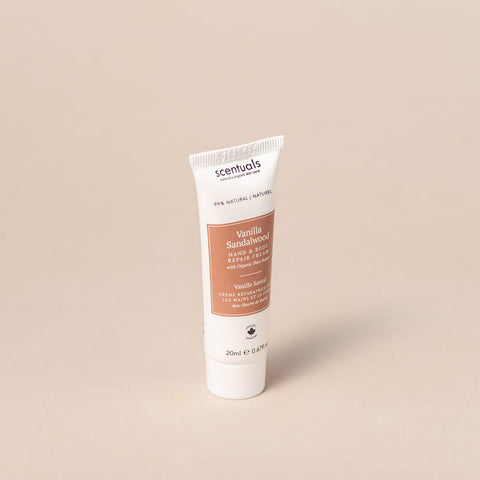 Tube of Vanilla Sandalwood hand cream by Scentuals on a beige background