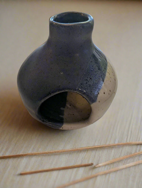 Ceramic vase with two-tone design on a light surface
