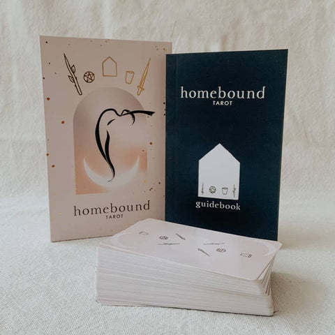 Homebound Tarot cards with guidebook on a textured surface