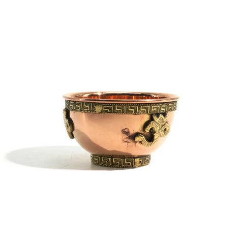 Copper bowl with gold decorative elements on a white background