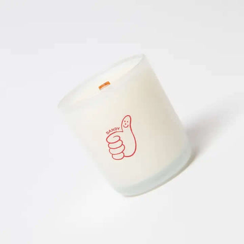 White milkjar candle with a red logo on a white background