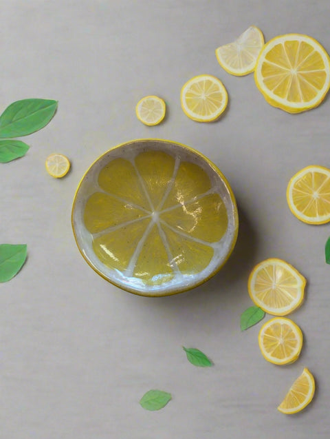 Decorative item shaped like a lemon slice on a plain background