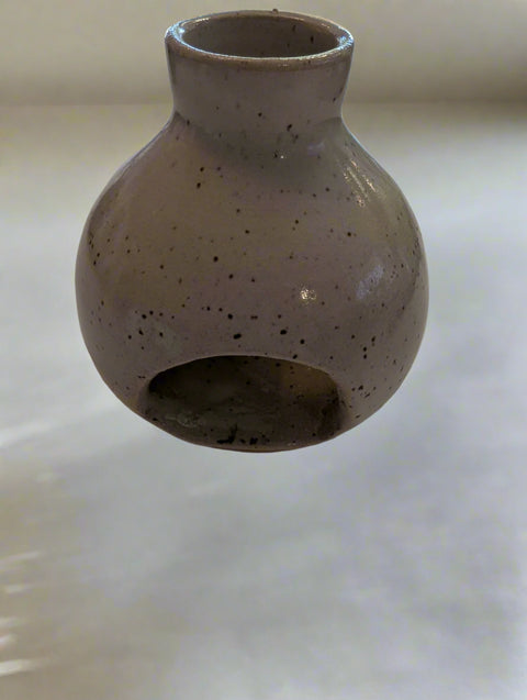 Ceramic vase with textured surface on a plain background