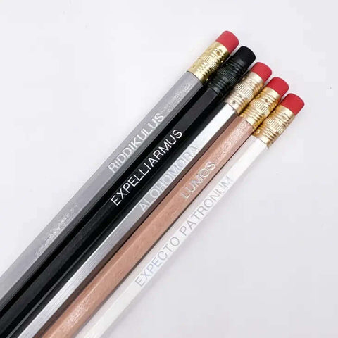 5 pencils with spell charms written on