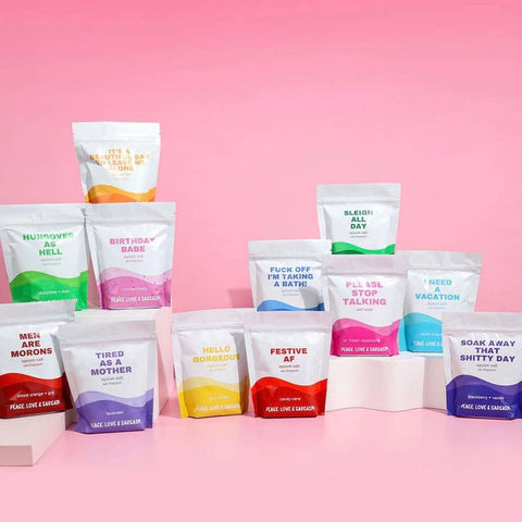 Assorted bags with humorous text on a pink background