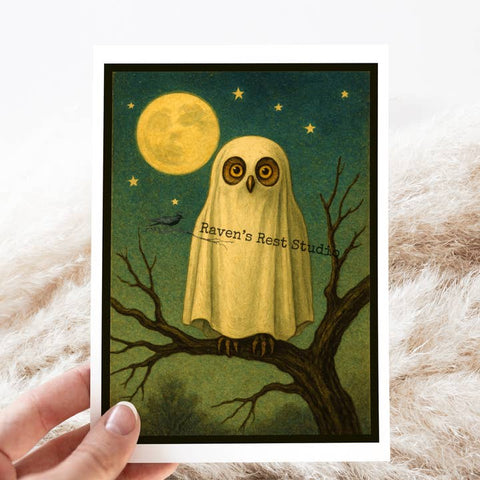 Illustration of an owl in a ghost costume on a branch with a moon and stars in the background, held by a hand.