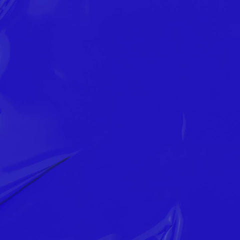 Close-up of blue nail polish with a brush on a blue background