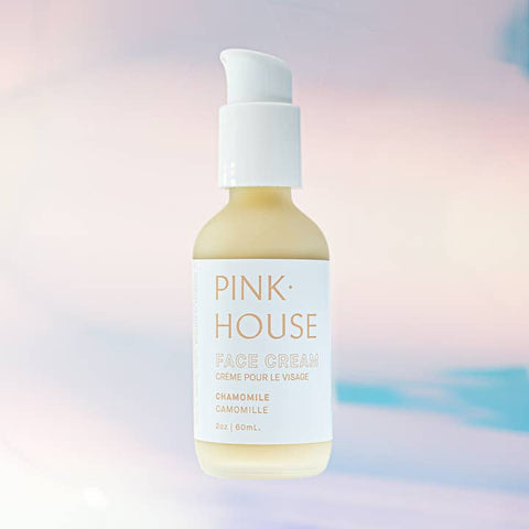Pink House face cream bottle on a pastel gradient background