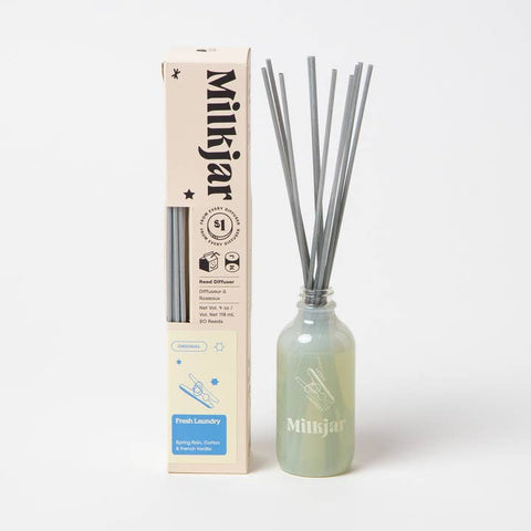 Milkjar diffuser bottle with sticks and packaging on a white background