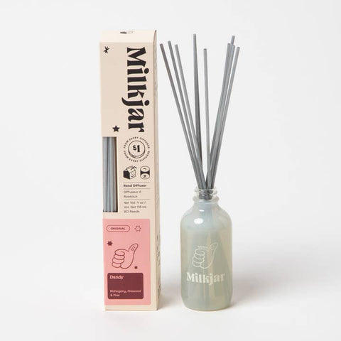 Milkjar diffuser bottle with reeds and packaging on a white background