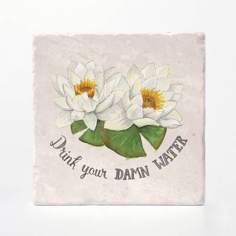 Coaster with white waterlilies and text 'Drink your DAMN water' on a light background