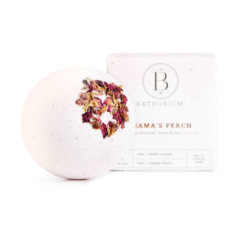 Bath bomb with floral top and Bathorium packaging on a white background