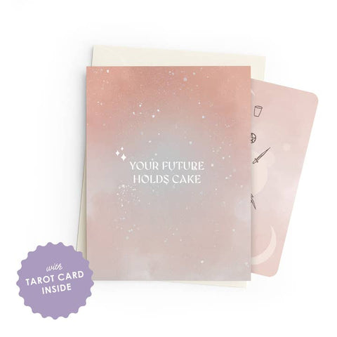 A pastel pink and peach greeting card with white text reading 'YOUR FUTURE HOLDS CAKE,' shown with a cream envelope and a pink tarot card peeking out behind it. A purple badge in the lower left says 'with TAROT CARD INSIDE.