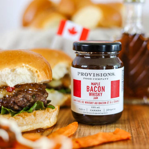 Burger with a jar of Provisions Maple Bacon Whisky Jam on a wooden surface