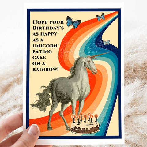 unicorn on a rainbow eating cake