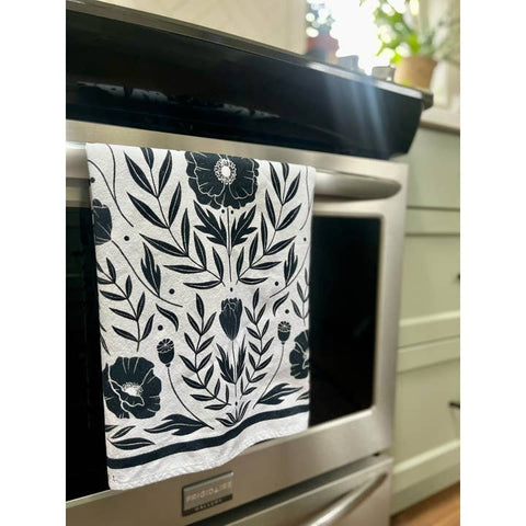 Floral patterned towel hanging on a kitchen appliance