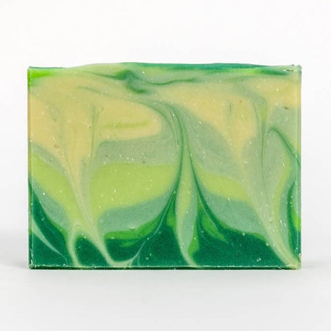 Green and yellow swirled soap bar on a white background