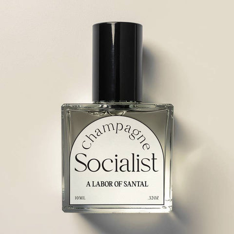 Perfume bottle labeled 'Champagne Socialist' by A Labor of Santal on a beige background