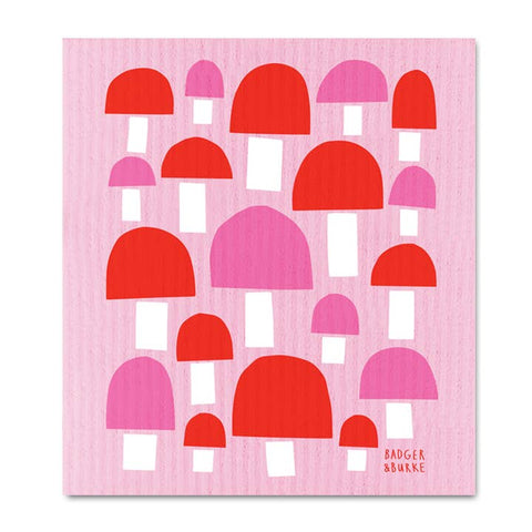 Pink and red patterned towel with 'Badger & Burke' branding on a pink background