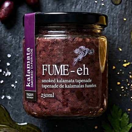 Jar of Fume-eh smoked kalamata tapenade on a dark background
