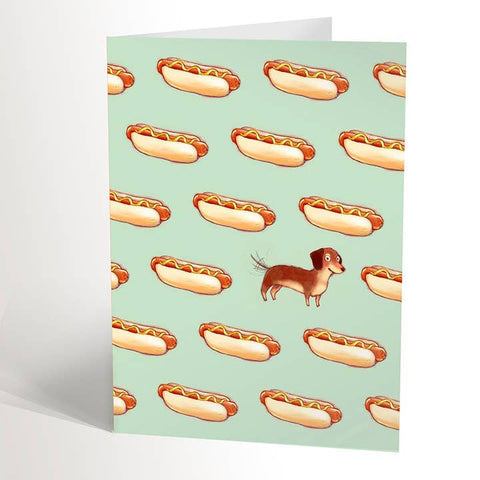 Greeting card with hot dog pattern and a small dog illustration on a light green background
