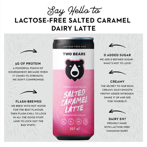 A single can of Two Bears Lactose-Free Salted Caramel Latte centered on a light gray background with marketing text and arrows around it. The can is mostly white at the top with a pink gradient lower half and a black bear logo.