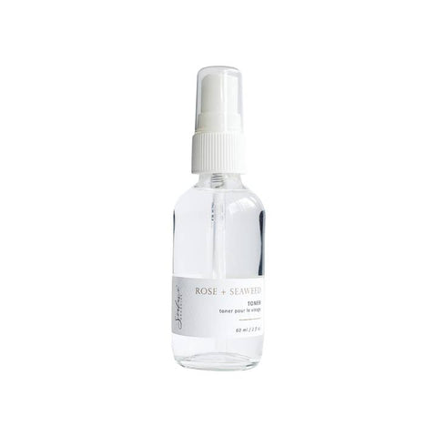Clear spray bottle with white cap on a white background