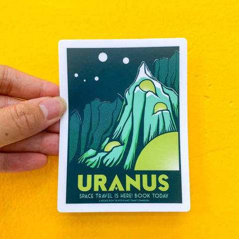 Sticker of Uranus held against a yellow background