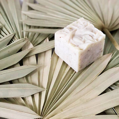 Square bar of soap on a palm leaf