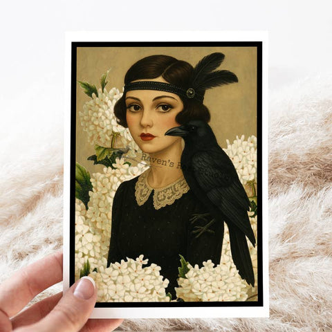 Vintage-style illustration of a woman with a black bird on a white floral background, held by a hand.