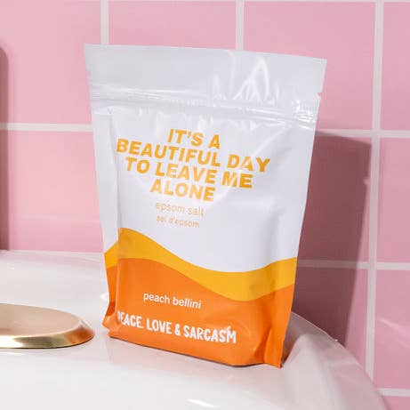 Packaged salt soak with text on a pink tiled background