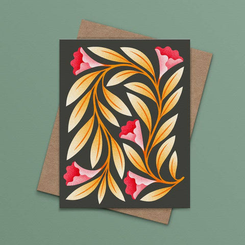 Greeting card with floral design on a brown envelope against a green background