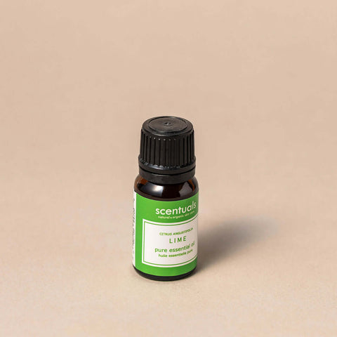 Scentuals lime essential oil bottle on a beige background
