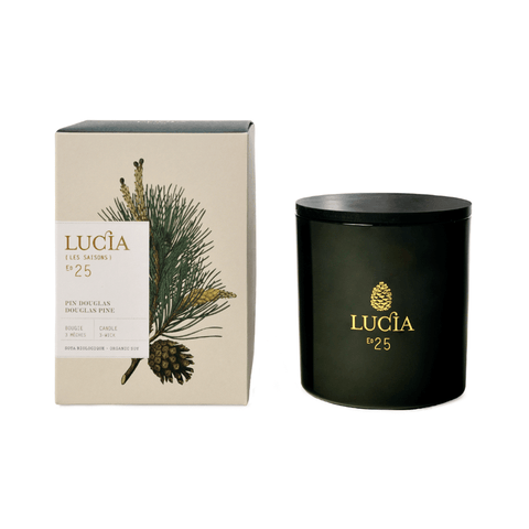 Dark Green Lucia candle with packaging featuring pine branch and pine cone design on a white background