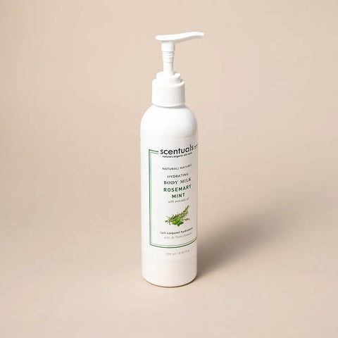 Scentuals body milk bottle with pump on a beige background