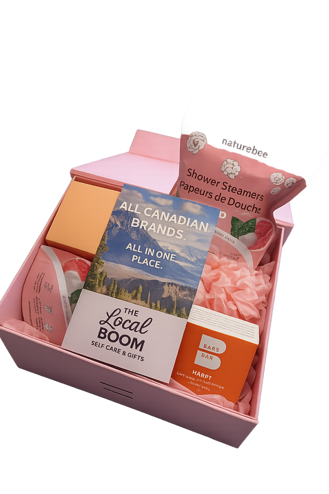 Pink gift box with self-care products including shower steamers and soap bars, branded 'naturebee' and 'The Local Boom'.