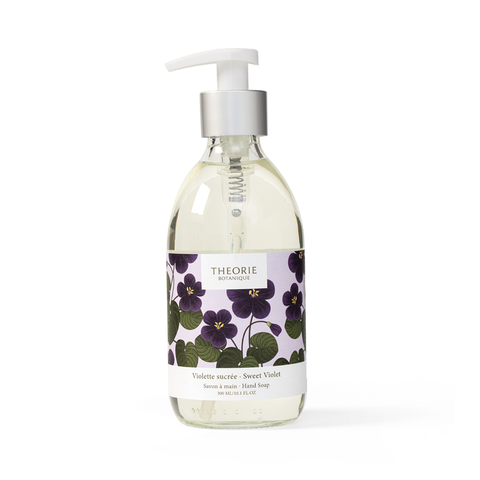 Hand soap bottle with floral label on a white background