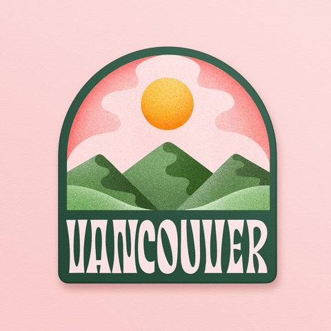 Sticker with 'Vancouver' text and mountain and sun design on a pink background