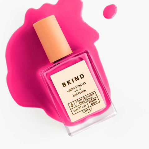 Pink nail polish bottle with 'BKIND' branding on a white background