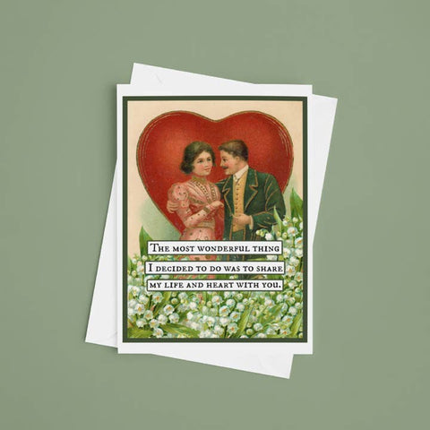 Vintage-style greeting card with a couple and heart design on a green background