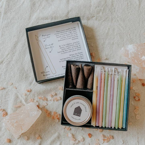 Incense cones in a box with a candle illustration and text on a textured fabric background