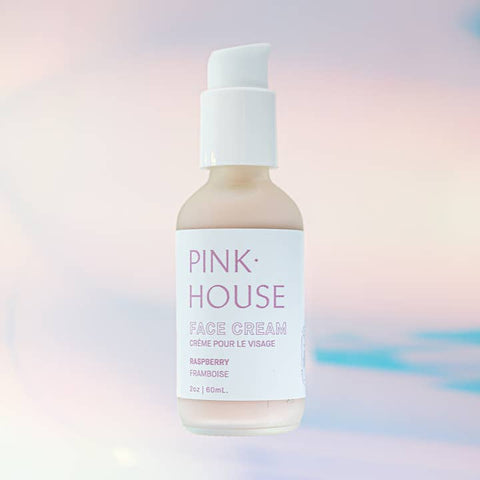 Pink House face cream bottle on a soft pastel background