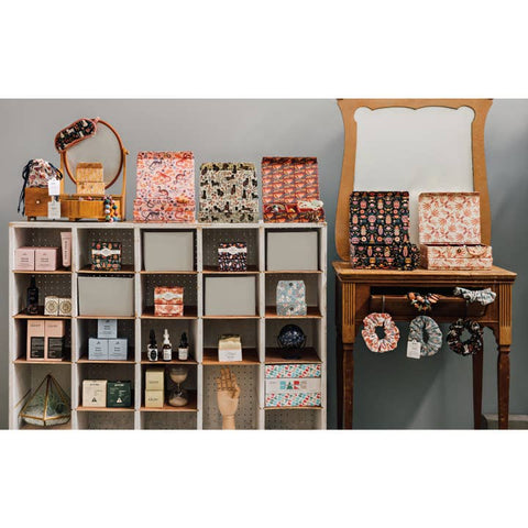 Display of decorative items including boxes, bags, and hair accessories on a shelf and table.