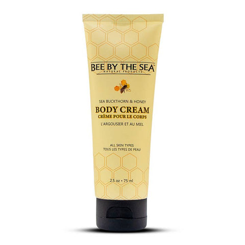 A 75 ml squeeze tube of 'Bee By The Sea' Sea Buckthorn & Honey Body Cream, featuring a pale yellow honeycomb-patterned tube and a black cap, set against a plain white background.