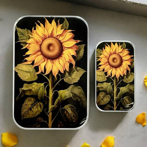 Two rectangular containers with sunflower designs on a gray surface.